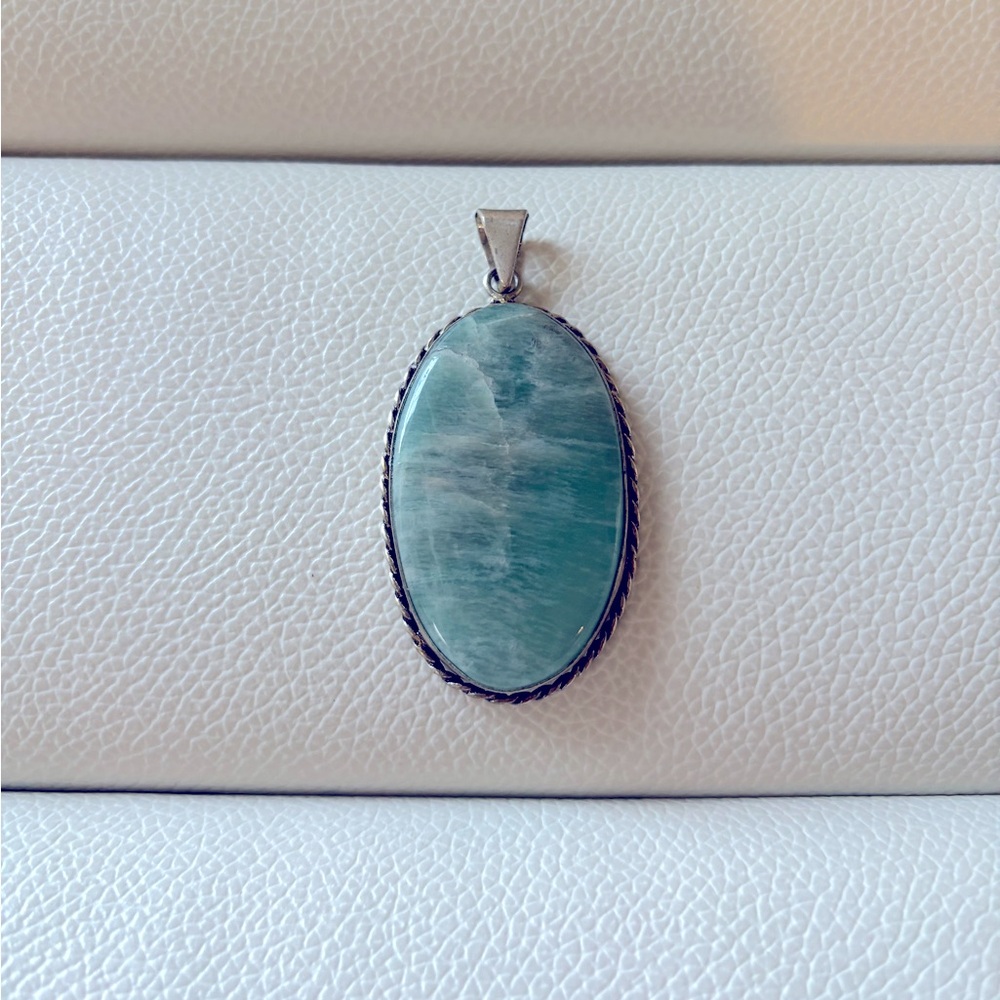 Oval silver pendant with teal stone